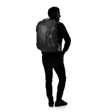 Load image into Gallery viewer, The black outline of a model carrying the backpack. 

