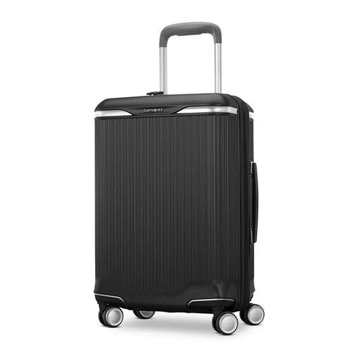 Angled front panel view of a black suitcase. 