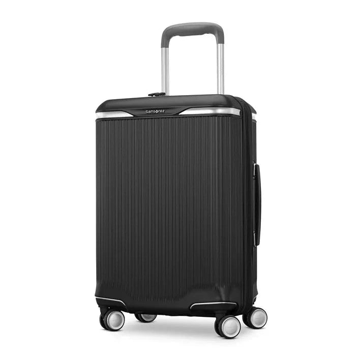 Angled front panel view of a black suitcase. 