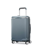 Load image into Gallery viewer, Angled front panel view of the slate blue suitcase. 
