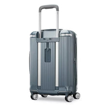 Load image into Gallery viewer, Angled back panel view of the slate blue suitcase. 
