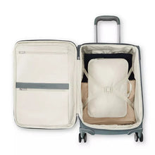 Load image into Gallery viewer, Interior view of the slate blue suitcase with a packing bag in the main compartment. 
