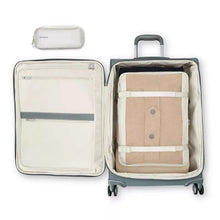 Load image into Gallery viewer, Interior view of the suitcase featuring the packing cube inside. The front panel features a set of zipper-closing pockets. The main compartment has a set of straps to hold your contents in place. 
