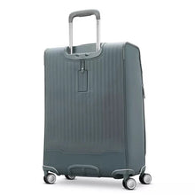 Load image into Gallery viewer, Angled back panel view of the slate blue suitcase. It features an ID tag under the telescopic handle. 
