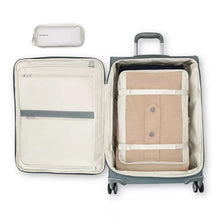Load image into Gallery viewer, Interior view of the suitcase with a packing cube in the main compartment. The front panel side features a set of zipper-closing pockets. 
