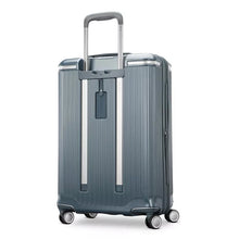 Load image into Gallery viewer, Angled back panel view of the slate blue suitcase. It features an ID tag. 
