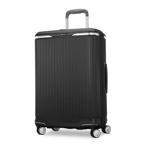 Angled front panel view of the black suitcase. 
