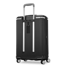 Load image into Gallery viewer, Angled back panel view of the black suitcase. It features a contact information tag. 
