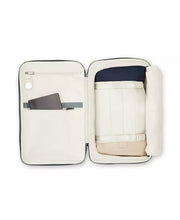 Load image into Gallery viewer, Interior view of the navy backpack with accessories organized inside. 
