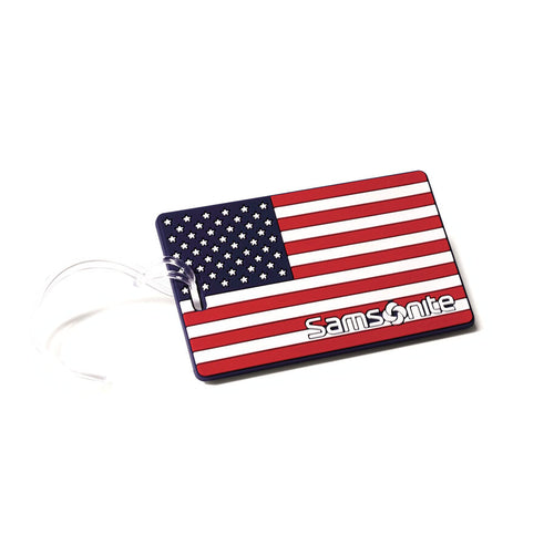 On a white background: An American flag ID tag with the Samsonite logo at the bottom right corner.