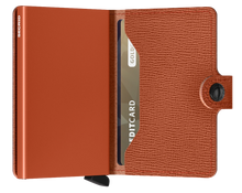 Load image into Gallery viewer, Interior view of the pumpkin mini wallet. The aluminum card case is a patching pumpkin color. 

