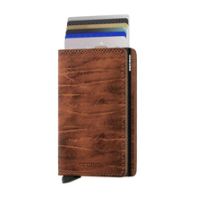 Load image into Gallery viewer, Angled front view of the Whiskey slim wallet with credit cards peeking from the compartment. 
