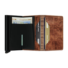 Load image into Gallery viewer, Interior view of the whiskey wallet with credit cards in the pockets and cash in the money clip
