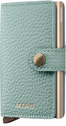 Angled front panel view of the sea green card case with a sand colored aluminum case inside. 