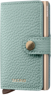 Angled front panel view of the sea green card case with a sand colored aluminum case inside. 