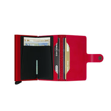 Load image into Gallery viewer, Interior view of the red mini wallet with cash in the money clip and cards in the pockets.
