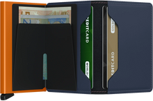 Load image into Gallery viewer, Interior view of the orange and blue slim wallet. The back of the aluminum card case features a money clip. The right side features two credit card pockets. 
