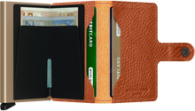 Load image into Gallery viewer, Interior view of the tan brown wallet. The let side features a bill clip, and the right side two card compartments. 
