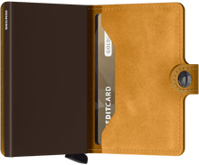 Load image into Gallery viewer, Interior view of the ochre yellow mini wallet. The aluminum case is a chocolate brown color.
