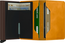 Load image into Gallery viewer, Interior view of the ochre yellow mini wallet. The back of the aluminum card case features a money clip. 

