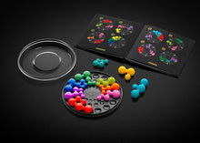 Load image into Gallery viewer, The game arranged with the booklet and pieces on a black surface
