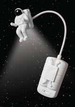 Load image into Gallery viewer, The space man book light on a black starry background.
