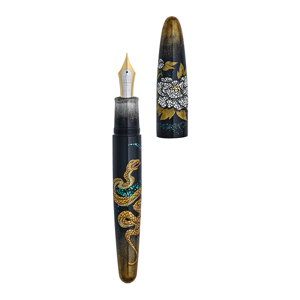 Fountain pen with snake and floral design on a white background, the pen is uncapped demonstrating its two toned nib.