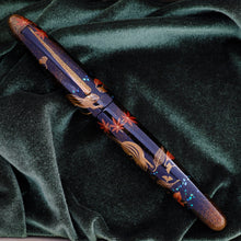 Load image into Gallery viewer, Front view of the fountain pen with the cap on. Laid on the soft green felt of the presentation box. 
