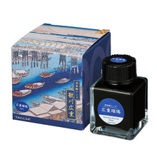 Load image into Gallery viewer, Taccia Hiroshigue Ruri ink bottle and packaging with Japanese woodblock print designs on a white background. The ink is a royal blue color.
