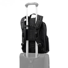 Load image into Gallery viewer, Back panel view of the backpack showing the attachment strap holding it to a suitcase&#39;s telescopic handle. 
