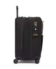 Load image into Gallery viewer, Side panel view of the black suitcase with golden accents. it features a grab handle, an expandable option, and an ID tag. 
