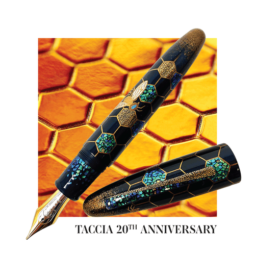 The fountain pen with the cap set to the side. The background has a close up to a golden-colored honey bee cells.