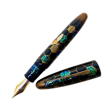 Load image into Gallery viewer, Front view of the fountain pen with the cap set to the side. 

