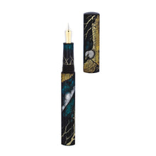 Load image into Gallery viewer, Front view of the Chinkin Eagle fountain pen with the cap set to the side, showing the two-toned 18 carat nib. The grip section features matching decorations to the pen&#39;s. 
