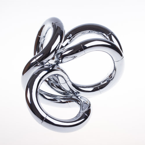 A chrome coy olored sculptural art piece with a fluid, organic design, resembling a knot or tangle.