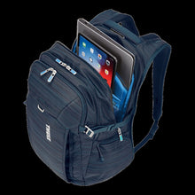 Load image into Gallery viewer, Angled view of the top panel. The main compartment is unzipped, and a laptop and tablet are fitted in their padded pockets. (Accessories not included).
