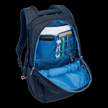 Load image into Gallery viewer, Angled front panel view of the front pocket unzipped. A battery bank, notebook, charging cable, keys and pens are organized within. (Accessories not included).
