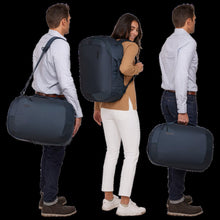 Load image into Gallery viewer, Three models carrying the bag in the three available ways: As a messenger bag, as a backpack with the shoulder straps, and as a suitcase with the side-panel grab handle. 
