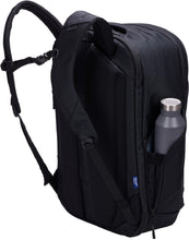 Load image into Gallery viewer, Angled back panel view of the backpack with the shoulder straps extended and a water bottle in the side pocket. (Water bottle not included).
