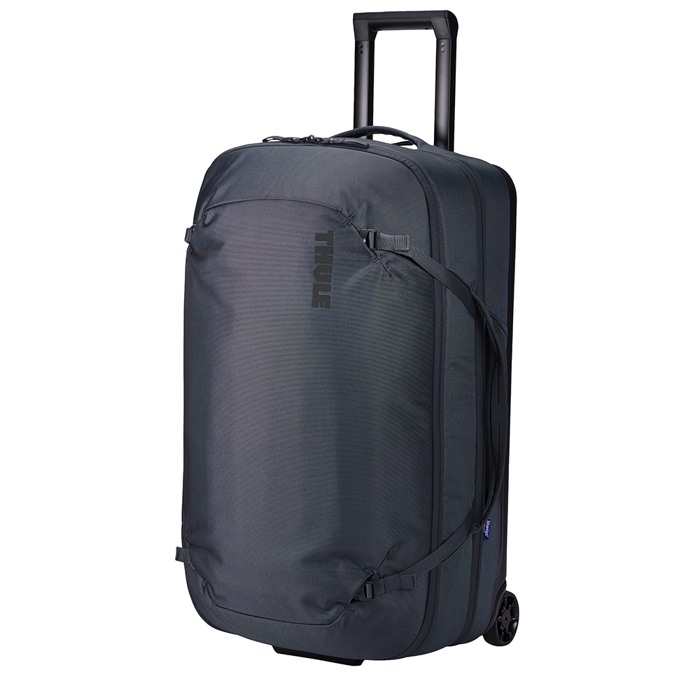 Angled front panel view of the Dark Slate wheeled duffle with the telescopic handle partly extended. 