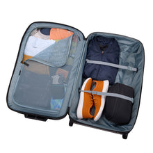 Load image into Gallery viewer, Interior view of the black suitcase filled with clothes and travel accessories. 
