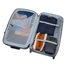 Load image into Gallery viewer, Interior view of the Dark Slate suitcase filled with clothes and travel accessories.
