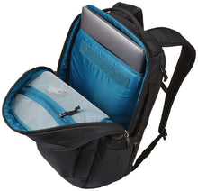 Load image into Gallery viewer, Angled top view of the black backpack with the main compartment unzipped. A laptop is shown tucked inside the back panel&#39;s pocket. 
