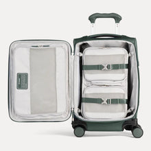 Load image into Gallery viewer, Interior view of the green suitcase with two packing cubes shown tied in the main compartment&#39;s adjustable straps. 
