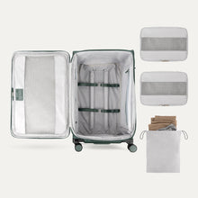 Load image into Gallery viewer, Interior view of the suticase arranged next to two packing cubes and a laundry bag. 
