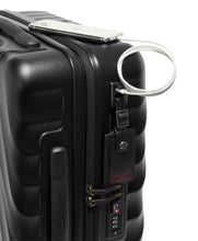 Load image into Gallery viewer, Close up to the side panel of the suitcase showing the USB plug you can use to charge your mobile devices. A battery bank is required and not included. 

