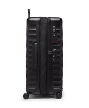 Load image into Gallery viewer, Side panel view of the suitcase on a white background. It features a grab handle, a tag, and a TSA approved three-digit combo lock. 
