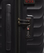 Load image into Gallery viewer, Close up to the side panel. it features a grab handle, a tag, and a TSA-approved three-digit combo lock. 
