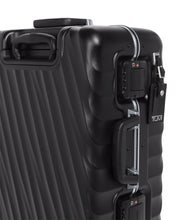 Load image into Gallery viewer, Angled close up to the side panel showing a tag, and two TSA approved three-digit combination locks. 
