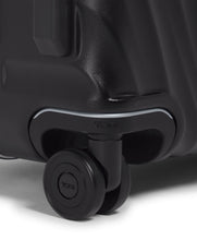 Load image into Gallery viewer, Close up to a tire on the bottom corner of the suitcase.
